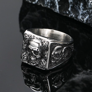 Macro detail of Gothic skull and rose engraving on a vintage steel ring for men