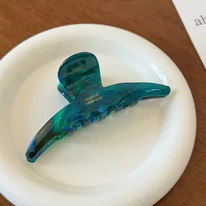 Detail of green marble acetate hair claw clip with gold France Handmade lettering