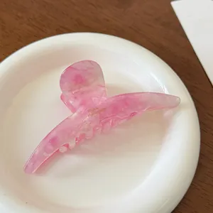 Detail of pink marble acetate hair claw clip with FRANCINE Handmade logo engraving