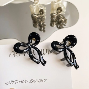 Elegant black hair claw clip with white polka dots and sweet bow design for women