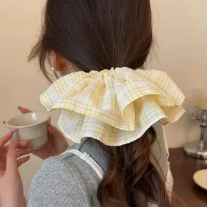 Sweet yellow plaid oversized scrunchie for women shown on model hair back view