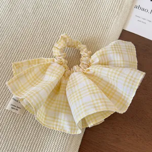Yellow and white checkered oversized scrunchie hair tie with soft pleated fabric design