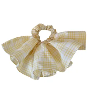 Sweet yellow plaid scrunchie with ruffled edges and fashionable large intestine style