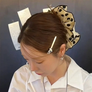 Polka dot silk hair scrunchie set with heart hair clip and silver earrings on model
