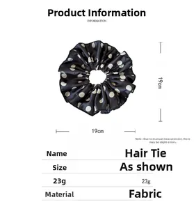 Detail showing oversized black polka dot fabric scrunchie with 19cm diameter specifications
