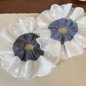 Oversized retro lace hair scrunchies with blue plaid and grey patterns on beige background