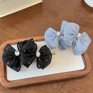 Elegant bow hair claws with sparkling rhinestones and mesh fabric in black and blue colors
