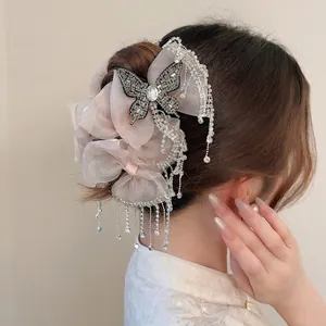 Elegant champagne pink mesh bow hair claw with crystal butterfly and long tassel charms