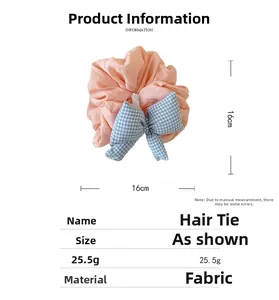 Detailed view of 16cm orange crepe scrunchie with blue checkered bow accessory