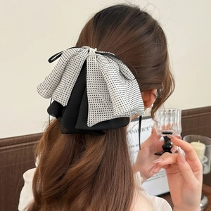 French style polka dot mesh bow hair clip with pearls shown on model's hair