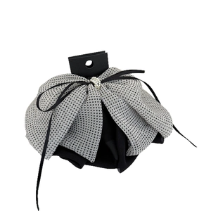 Elegant black polka dot mesh hair clip with large bow, faux pearls and long ribbons