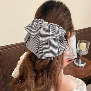 Elegant black and white striped mesh bow hair clip with pearl detail for women