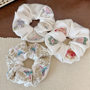 Broderies détaillées de papillons et lotus sur chouchous élégants en soie de couleur crème