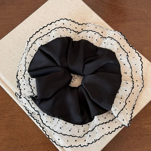 Detail of double-layer mesh lace scrunchie with black and white polka dot design
