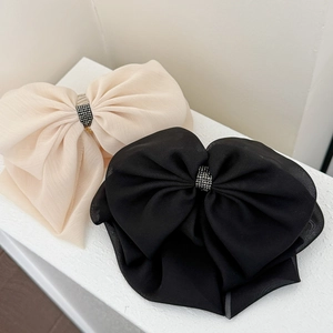 Elegant oversized tulle bow hair clips in beige and black with sparkling rhinestone centers