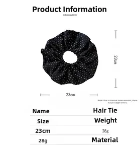 Detailed view of polka dot scrunchie with 23cm diameter size and fabric material details