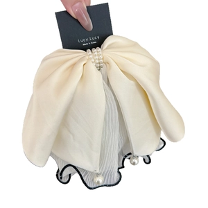 French style cream satin bow hair claw with pearls and pleated mesh veil on a card