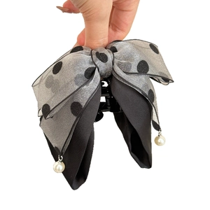 Elegant grey polka dot bow hair clip with pearl pendants on a white background