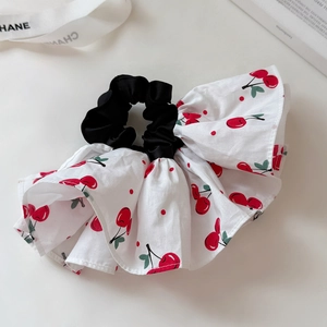 Detailed macro view of high-quality large hair scrunchie with sweet red cherry pattern