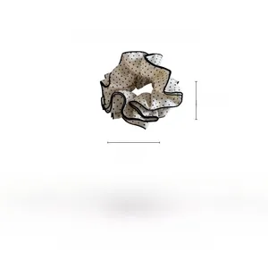 Detailed view of large black and white polka dot scrunchie with 16cm outer diameter size