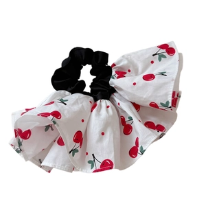 Elastic cherry print scrunchie hair tie with white fabric and red cherry patterns