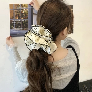 Polka dot layered scrunchie hair tie in beige fabric with black ruffled edges