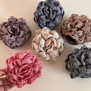Detailed close-up of plaid fabric rose hair clips in six assorted elegant colors