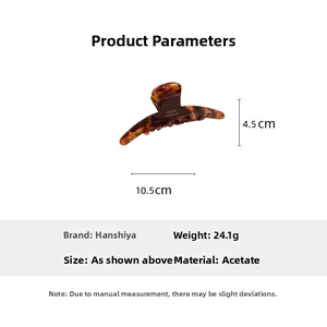 Detailed view of handmade acetate hair claw with tortoise pattern and size dimensions