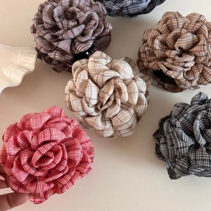 Close-up of British style plaid rose hair claws in various elegant checkered patterns