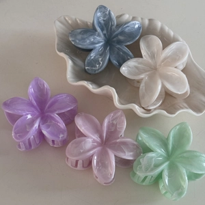 Five marble texture frangipani flower hair claws in assorted pastel colors for women