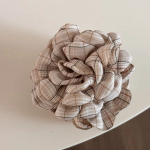 Detailed close-up of a British style plaid fabric rose hair clip with multilayered petals