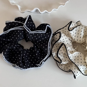 Detail of black and white polka dot organza scrunchies with elegant ruffled edges