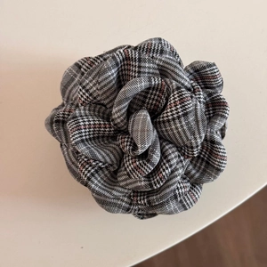 Close-up of British plaid rose flower hair claw clip with elegant houndstooth pattern fabric