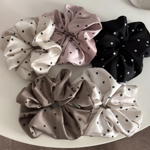 Satin daisy print scrunchies set in cream, pink, black, and brown with elegant silk shine