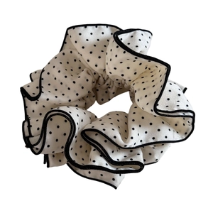 Polka dot four-layer layered scrunchie with black ruffled edges on a white background