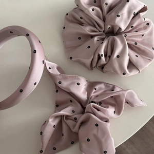 Detail of pink floral satin hair set with scrunchie, headband and long ribbon