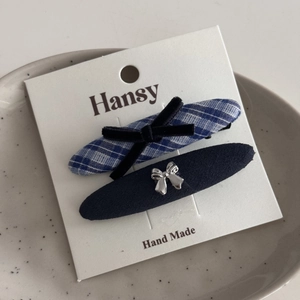 Detailed set of blue plaid bow hair clip and navy matte clip on display card