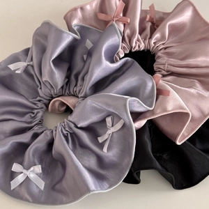 Three premium satin scrunchies with elegant bow details in purple, pink, and black colors