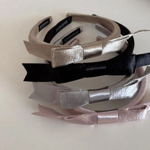 Détail de serre-têtes faits main avec double nœud en satin en quatre coloris élégants