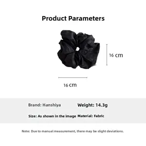 Detail of 16cm black fabric scrunchie with textured pattern and product specifications
