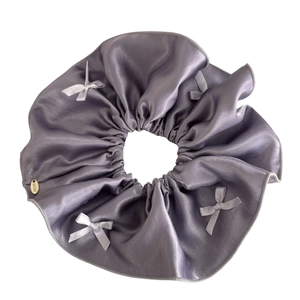 Lilac satin scrunchie with bows and a golden Lucky metal tag for elegant hairstyles