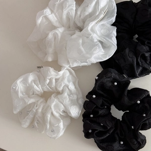 Detail view of premium chiffon scrunchies set with pearl embroidery in black and white