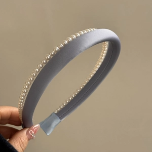 Close-up of elegant double-layered pearl headband in grey-blue satin finish