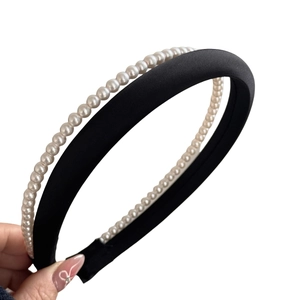Elegant double-layered headband with black satin padding and faux pearl embellishments