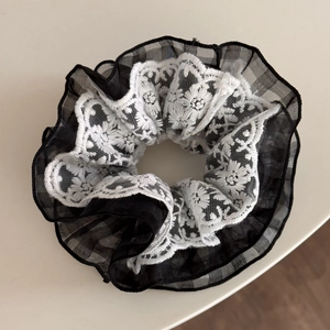 Detail of vintage double-layer lace scrunchie with floral embroidery and mesh