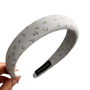 Floral padded sponge headband with blue flowers on cream base for high crown volume look