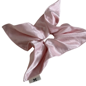 Lustrous cream pink satin square scrunchie with silk texture and woven brand label