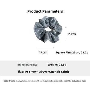 Macro detail of blue floral scrunchie showing soft fabric texture and 15cm diameter size