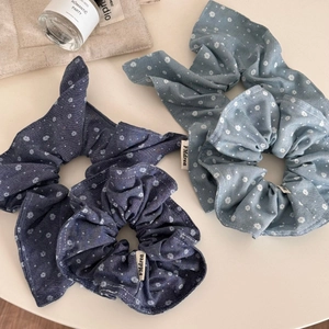 Three-piece set of floral denim blue scrunchies for hair styling with white flower pattern