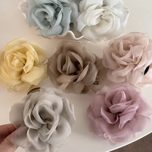 Detailed flat lay of fabric rose hair claws in seven elegant Morandi colors